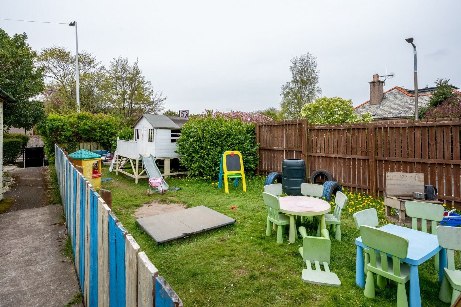 Gilmerton garden with playhouse and outdoor tables